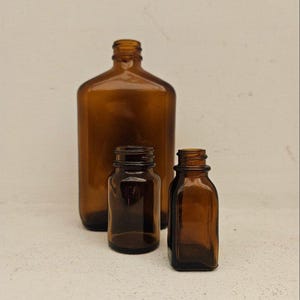 Beautiful set of three (3) vintage amber glass apothecary bottles