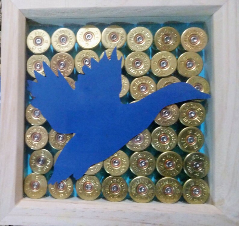 Framed Flying duck cutout with shotgun cartridge background