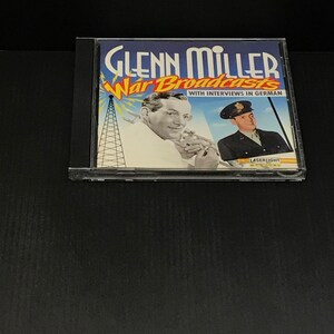 May include: A CD case featuring the album "Glenn Miller War Broadcasts." The cover art displays a vintage photograph of Glenn Miller and a soldier, with the title in blue and yellow. The text "With Interviews in German" is also visible.
