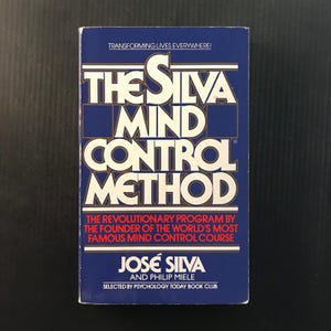 May include: A book titled "The Silva Mind Control Method" with a blue cover and white lettering. The book's title is prominently displayed, along with the author's name, José Silva, and the phrase "Transforming Lives Everywhere!"