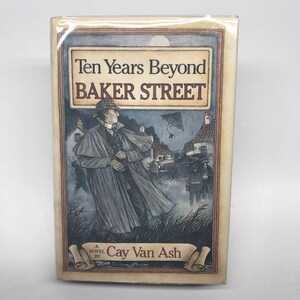 May include: A book cover with a dark blue background and a drawing of a man in a long coat and hat. The title of the book is "Ten Years Beyond Baker Street" and the author is "Cay Van Ash".