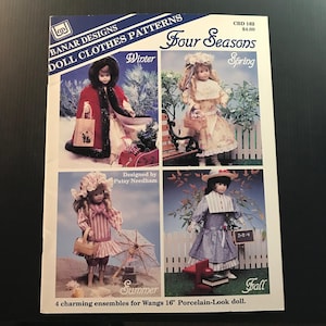 May include: A pattern for doll clothes by Banar Designs. The cover features four doll images representing the seasons: Winter, Spring, Summer, and Fall. The text reads "Four Seasons" and "Doll Clothes Patterns". The pattern is designed for Wangs 16" porcelain-look dolls.