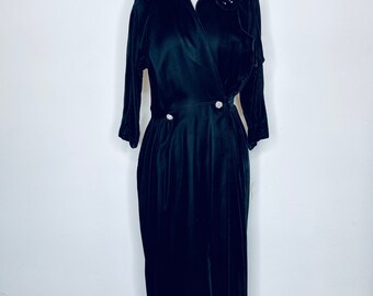 May include: A long black velvet dress with a collared neckline and pearl embellishments on the collar.