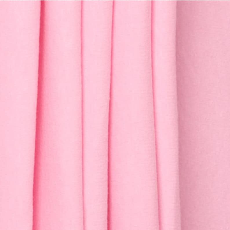 May include: Close-up of a soft, pink fabric with vertical folds. The fabric has a smooth, even texture.