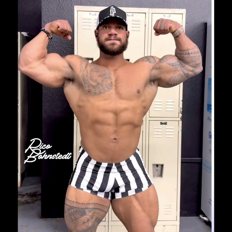 May include: A muscular person flexing their biceps, wearing a black and white striped shorts and a black cap. The person has tattoos on their arms and legs. The image includes the text "Rico Bohnstedt".