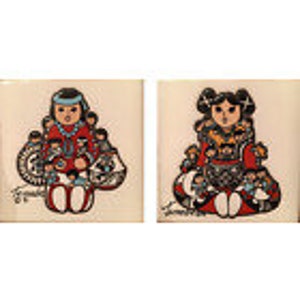 May include: Two ceramic tile coasters featuring illustrations of Native American girls in traditional clothing. The girls are sitting and holding items in their hands. The coasters are white with colorful designs.