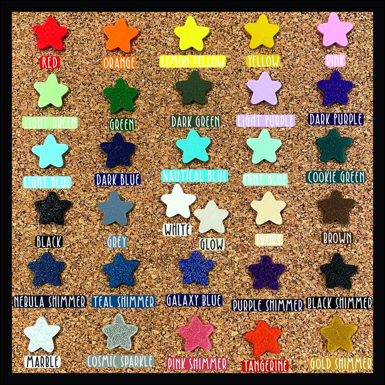 May include: A corkboard with a variety of star-shaped stickers in different colours and finishes. The colours include red, orange, yellow, green, blue, purple, black, white, brown, and grey. Some of the stars have a shimmer finish.