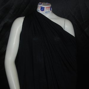 May include: Black fabric draped over a mannequin, showcasing the fabric's texture and drape.