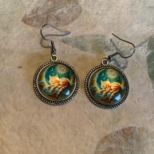 Orange kitten with orange moon earrings