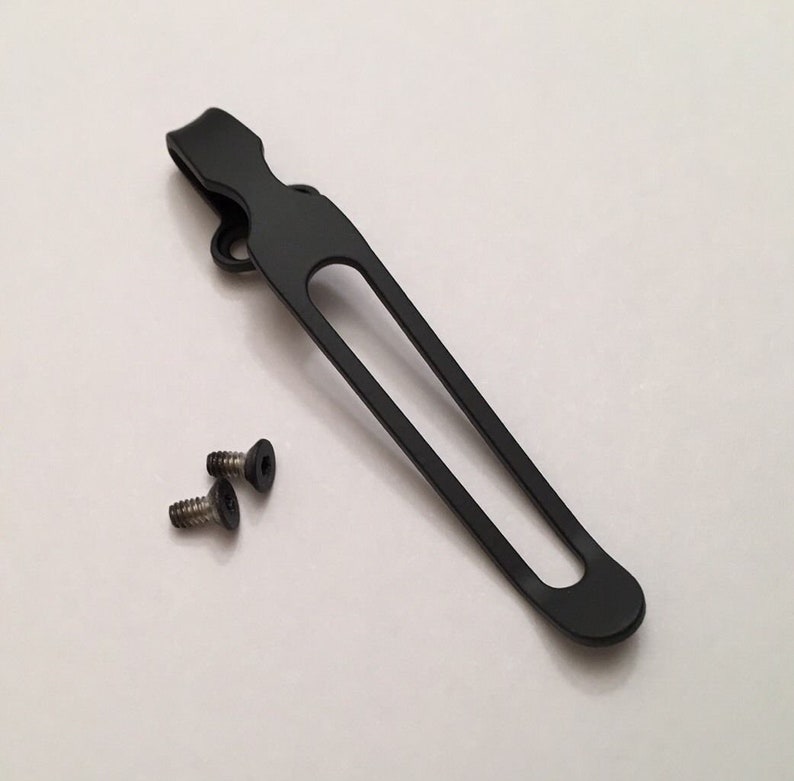 May include: Black metal pocket clip with two silver screws.