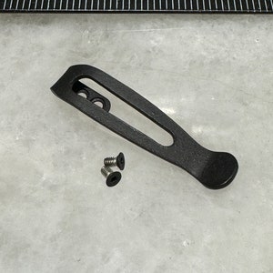May include: Black metal pocket clip with two small screws.