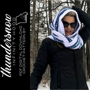 May include: A white and blue crochet infinity hood with a striped pattern. The hood is being worn by a person in a snowy woodland setting. The text "Thundersnow Infinity Hood" and "PDF Digital Download Crochet Pattern by" is visible on the left side of the image.