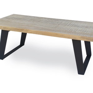 May include: A rectangular wooden coffee table with a natural wood finish and black metal legs. The table has a simple, modern design.