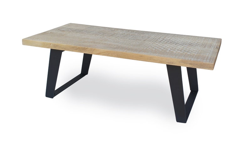 May include: A rectangular wooden coffee table with a natural wood finish and black metal legs. The table has a simple, modern design.