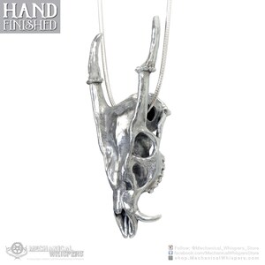 Muntjac deer skull pendant, highly detailed, designed from a 3D scan of an actual muntjac skull. Available in 3 metals: blackened steel, brass with a custom patina, and sterling silver with custom patina. 50mm tall.