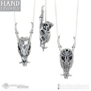 Muntjac deer skull pendant, highly detailed, designed from a 3D scan of an actual muntjac skull. Available in 3 metals: blackened steel, brass with a custom patina, and sterling silver with custom patina. 50mm tall.