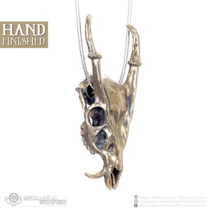 Muntjac deer skull pendant, highly detailed, designed from a 3D scan of an actual muntjac skull. Available in 3 metals: blackened steel, brass with a custom patina, and sterling silver with custom patina. 50mm tall.