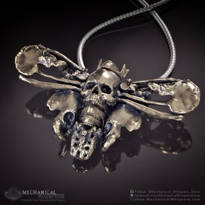 Deaths Head Hawkmoth pendant, highly detailed, designed from a 3D scan of an actual human skull and individual bones. Available in 3 metals: blackened steel, brass with a custom patina, and sterling silver with custom patina. 47mm width.