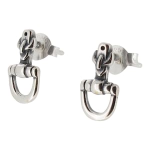 May include: A pair of silver earrings with a unique design featuring a small, detailed knot at the top and a horseshoe-shaped bottom.