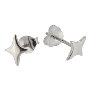 May include: A pair of polished silver stud earrings shaped like four-pointed stars. Each earring features a smooth, reflective surface and a standard post back with a butterfly clutch, showing clear metal hallmarks on the earring backing components.