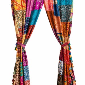 May include: A pair of vibrant patchwork curtains, featuring a variety of colorful fabric squares. The curtains are held by a wooden rod and tied with decorative tassels. The design includes shades of red, blue, yellow, and purple.