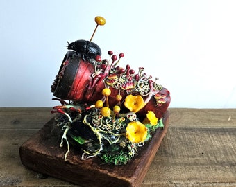 Flashlight decorated with polymer beetle and fungi.