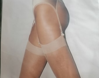 May include: Package of Wolford Individual 10 stockings. The stockings are a nude color and feature a garter belt design. The package has the Wolford logo and the words "INDIVIDUAL 10 STOCKINGS".