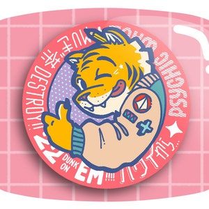 May include: A round, pink button with a cartoon tiger illustration. The tiger is wearing a blue and teal jacket and giving a thumbs up. Text includes "PSYCHIC" and "DUNK ON EM!!!"