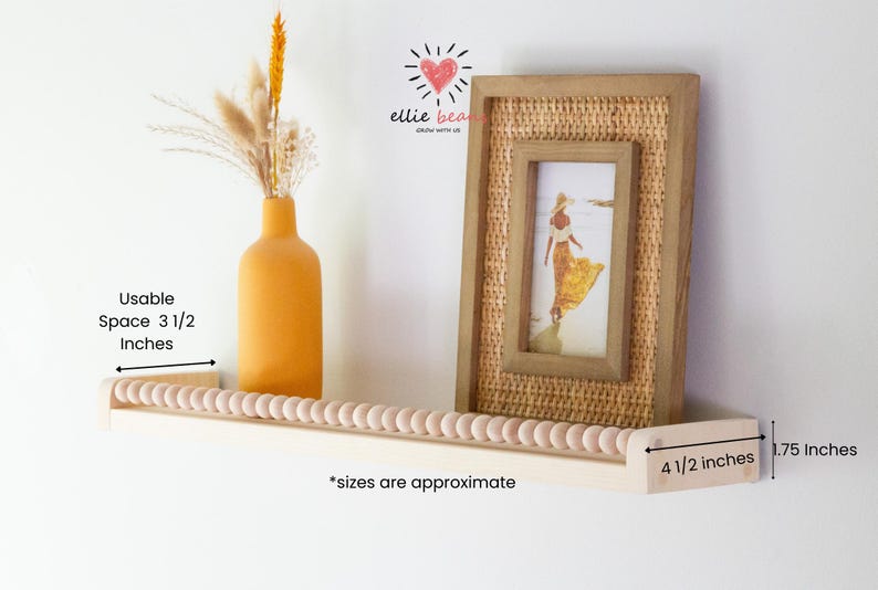 May include: A wooden shelf with a beaded edge, a framed picture, and a yellow vase with dried flowers. The shelf is 4.5 inches wide and 1.75 inches deep, with a usable space of 3.5 inches. The frame has a woven texture.