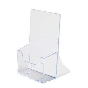 May include: Clear acrylic brochure holder with a slanted back and a pocket for leaflets. The holder is designed to display promotional materials and is suitable for retail or office use. The transparent design allows for easy viewing of the contents.