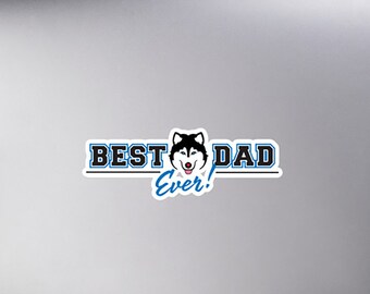 Könnte beinhalten: Ein Aufkleber mit einem Husky-Hundegesicht und dem Text "BEST DAD EVER!" in blauer und schwarzer Schrift.