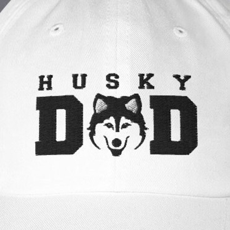 May include: White baseball cap with black embroidery that reads "Husky Dad" and features a black and white husky silhouette.