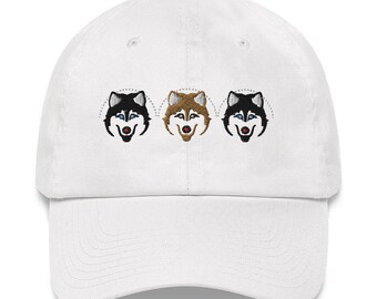 May include: White baseball cap with three embroidered husky faces. The huskies have black, brown, and white fur.