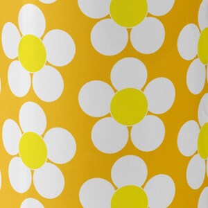 May include: A seamless pattern of white daisies with yellow centers on a bright orange background.