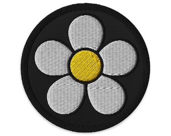 Vintage Daisy 1960s embroidered patch with white pedals yellow center. 3 inch diameter. Black background and black outline.