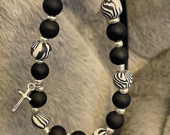 Matte black glass and zebra striped beads stretch bracelet with silver accents and cross
