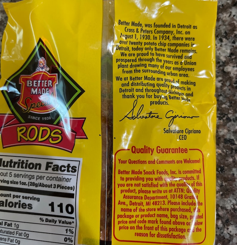 May include: A yellow bag of Better Made potato chips with the words "Better Made" and "Special Rods" in red and black lettering. The bag has a nutrition facts label and a quality guarantee statement. The statement includes the company's address and a phone number for customer service.