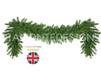 May include: A green artificial pine garland with dense needles. The text DIAMONTEDESIGNS is visible in the center. Below the text, the phrase Trusted UK Seller is displayed with five yellow stars and a circular icon of the United Kingdom flag.