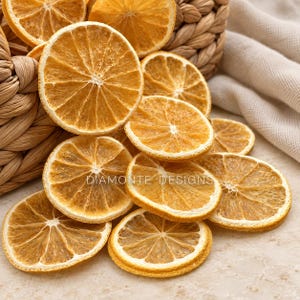 May include: A collection of dehydrated orange slices with a translucent, golden-yellow texture, arranged in and around a woven basket. The text DIAMONTE DESIGNS is visible across the centre of the orange slices in a clean, white font.
