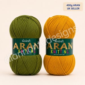 May include: Two balls of Woolcraft Aran knitting yarn, one olive green and one mustard yellow. Each ball features a label with the text Woolcraft ARAN KNITTING, 400g ARAN UK SELLER, and KNITS TO ANY ARAN PATTERN in gold and colourful lettering.