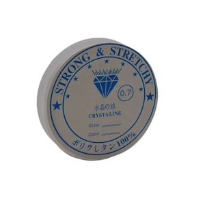 May include: A spool of clear, stretchy beading cord. The white label features blue text and a diamond graphic. Text includes "STRONG & STRETCHY", "CRYSTALINE", and "ボリウレタン100%" with a size of 0.7.