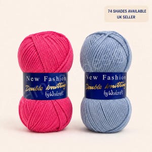 May include: Two balls of New Fashion Double knitting by Woolcraft yarn, one in bright pink and one in light blue. Each ball features a dark blue label with white and gold text. The top right corner displays the text 74 SHADES AVAILABLE UK SELLER.