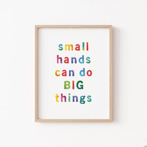 May include: A framed print with the text "small hands can do BIG things" in colorful letters. The letters are in different colors, including red, yellow, green, blue, and purple.