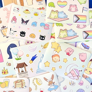 May include: A collection of colorful stickers featuring various characters and designs, including a cute cat, a well, a star, a moon, a frog, a heart, a rainbow, a mushroom, a flower, a castle, a clock, a butterfly, a harp, a shell, a pancake, a glass of juice, a peach, a kitty, a bird, a cloud, a star, a balloon, a Kirby character, a Pikachu character, and a Hello Kitty character.