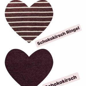May include: Two heart-shaped fabric swatches. One is a solid dark burgundy color, and the other has horizontal white stripes on a dark burgundy background. The text "Schokokirsch" is visible.