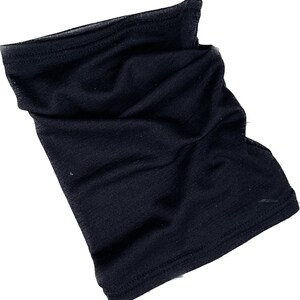 May include: A black neck gaiter made of a soft, stretchy fabric. The gaiter is a tube shape, designed to be worn around the neck and pulled up over the face. It appears to be new and unworn.
