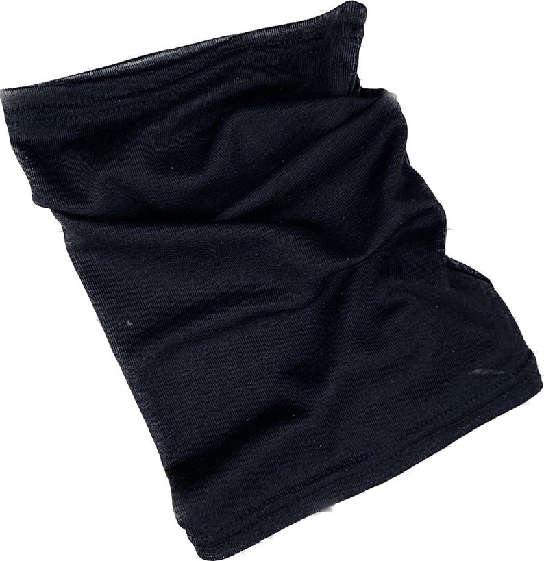 May include: A black neck gaiter made of a soft, stretchy fabric. The gaiter is a tube shape, designed to be worn around the neck and pulled up over the face. It appears to be new and unworn.