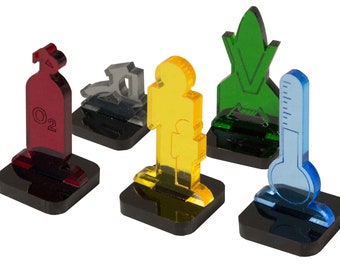 May include: Five different colored acrylic game pieces on black bases. The pieces are a red oxygen tank, a silver spaceship, a yellow person, a green rocket, and a blue thermometer.