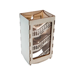 May include: A wooden box with a clear front panel, revealing a spiral staircase design. The box is made of light wood and has a natural finish.