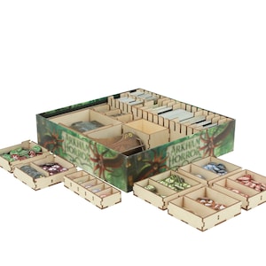 May include: A wooden organizer for the Arkham Horror board game. The organizer has compartments for cards, tokens, and other game components. The organizer is made of wood and has a green and brown design with the Arkham Horror logo.